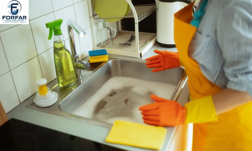 Local blocked toilet and sink unblocking Forfar specialist clearing slow-draining kitchen sink with mechanical drain snake equipment